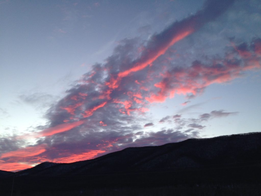 dramatic sunset with pink diagonal clouds