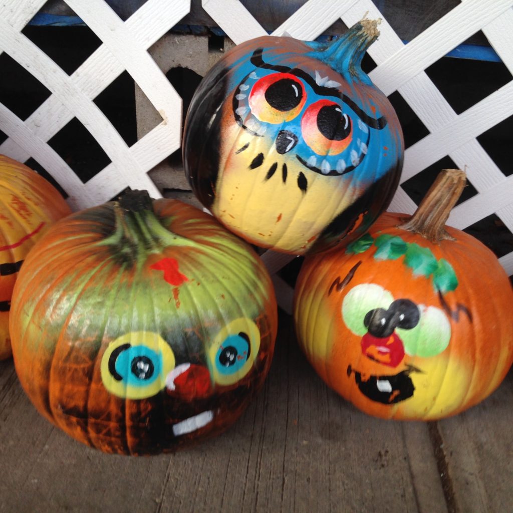 3 pumpkins painted with funny faces