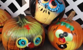 3 pumpkins painted with funny faces