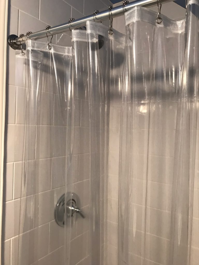 shower with clear shower curtain